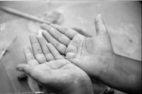 a black and white photo of a person's hands